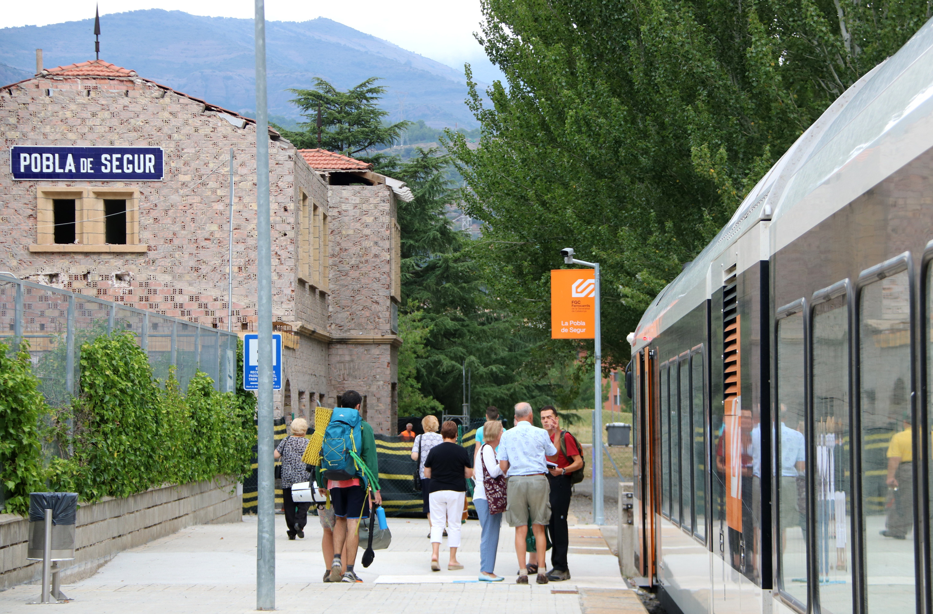 Un grup de persones esperant per pujar al tren a l'estació de la Pobla de Segur, al Pallars Jussà | ACN